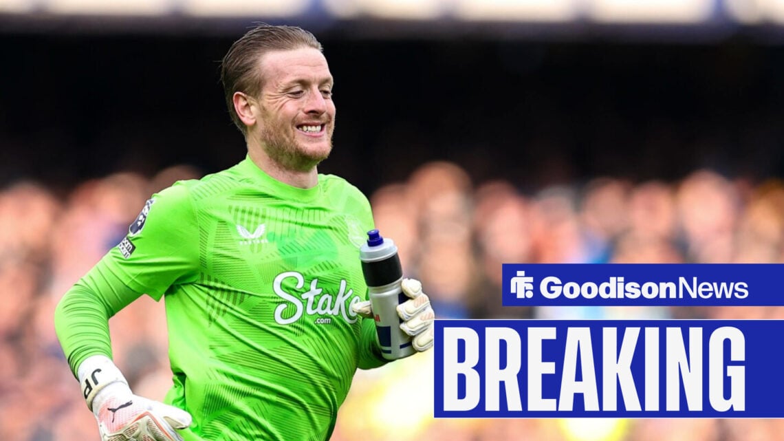 Jordan Pickford runs smiling with bottle in hand.