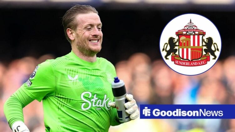 Jordan Pickford looking and smiling at the Sunderland badge.