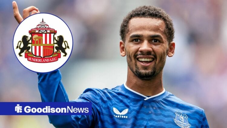 Iliman Ndiaye smiling and pointing at the Sunderland badge.