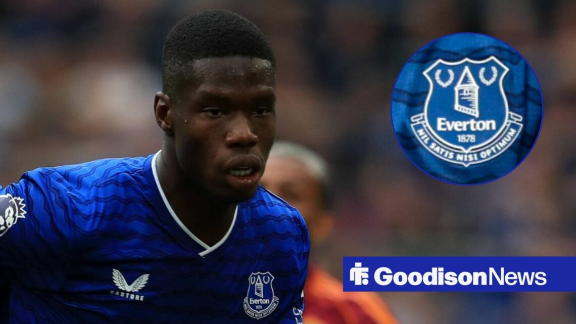 Thierno Barry playing for Everton looking towards an Everton badge in a circle inset