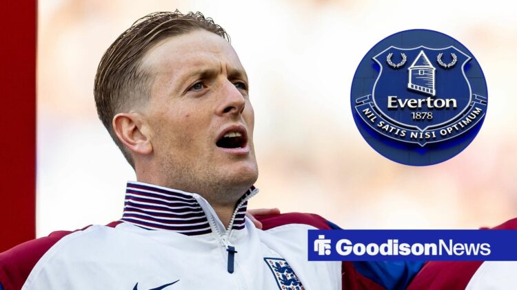 Jordan Pickford singing in England gear as he looks at the Everton badge.