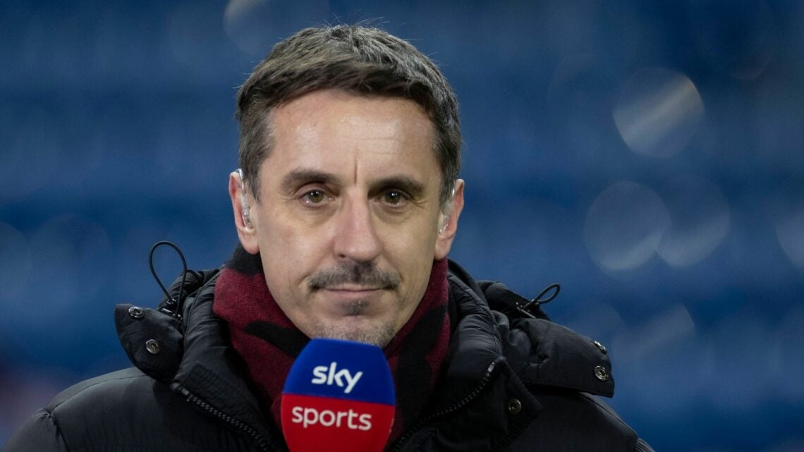Gary Neville holding a microphone to his mouth.
