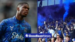 Thierno Barry looking in the direction of Everton fans who are holding flares inside Goodison Park.