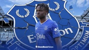 Tyrique George with a cracking Everton badge behind him.